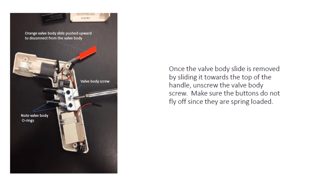 Once the valve body slide is removed by sliding it towards the top of the handle, unscrew the valve body screw. Make sure the buttons do not fly off once they are spring loaded.